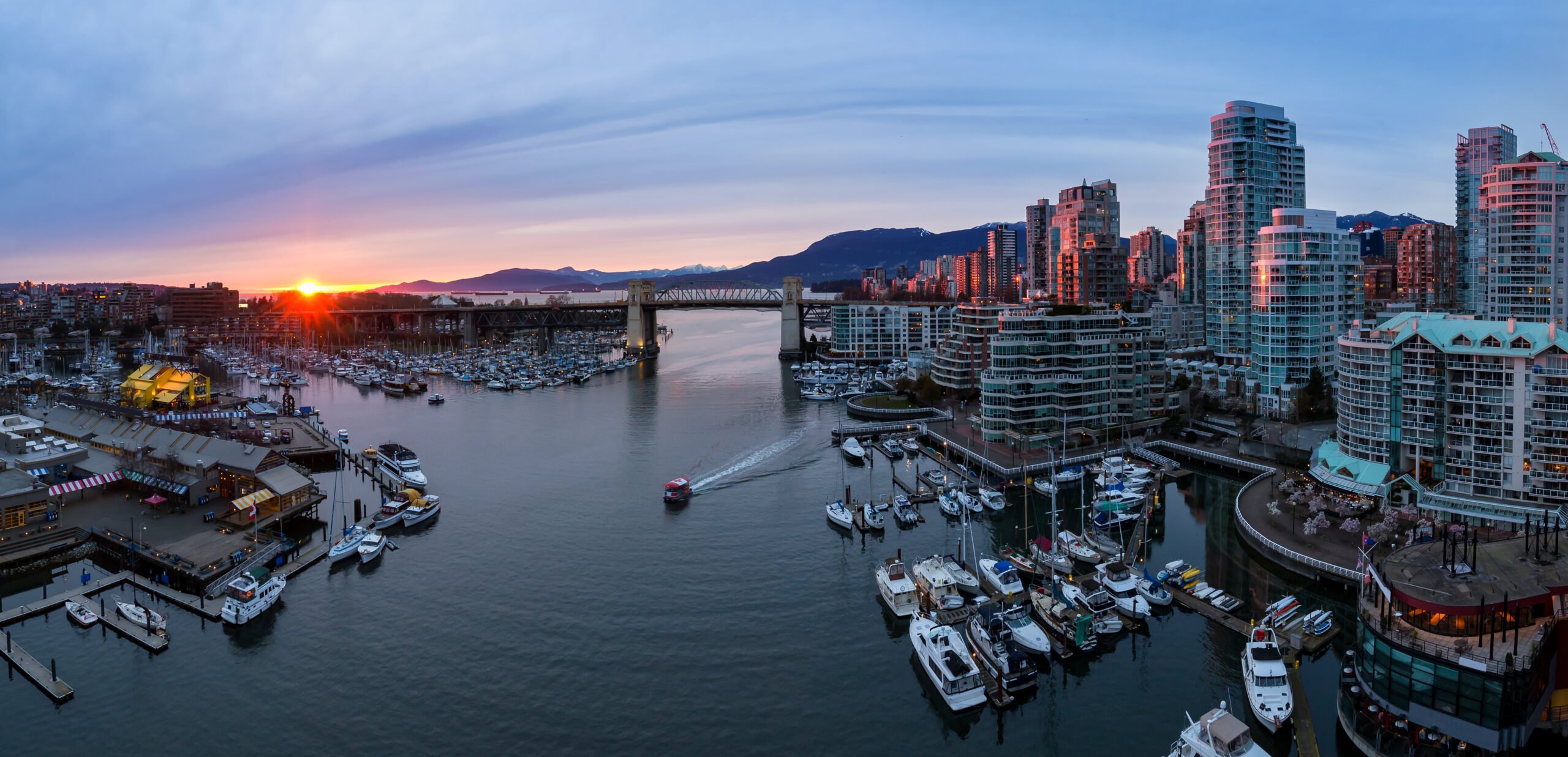 Marina and condo towers along False Creek in Yaletown at sunset