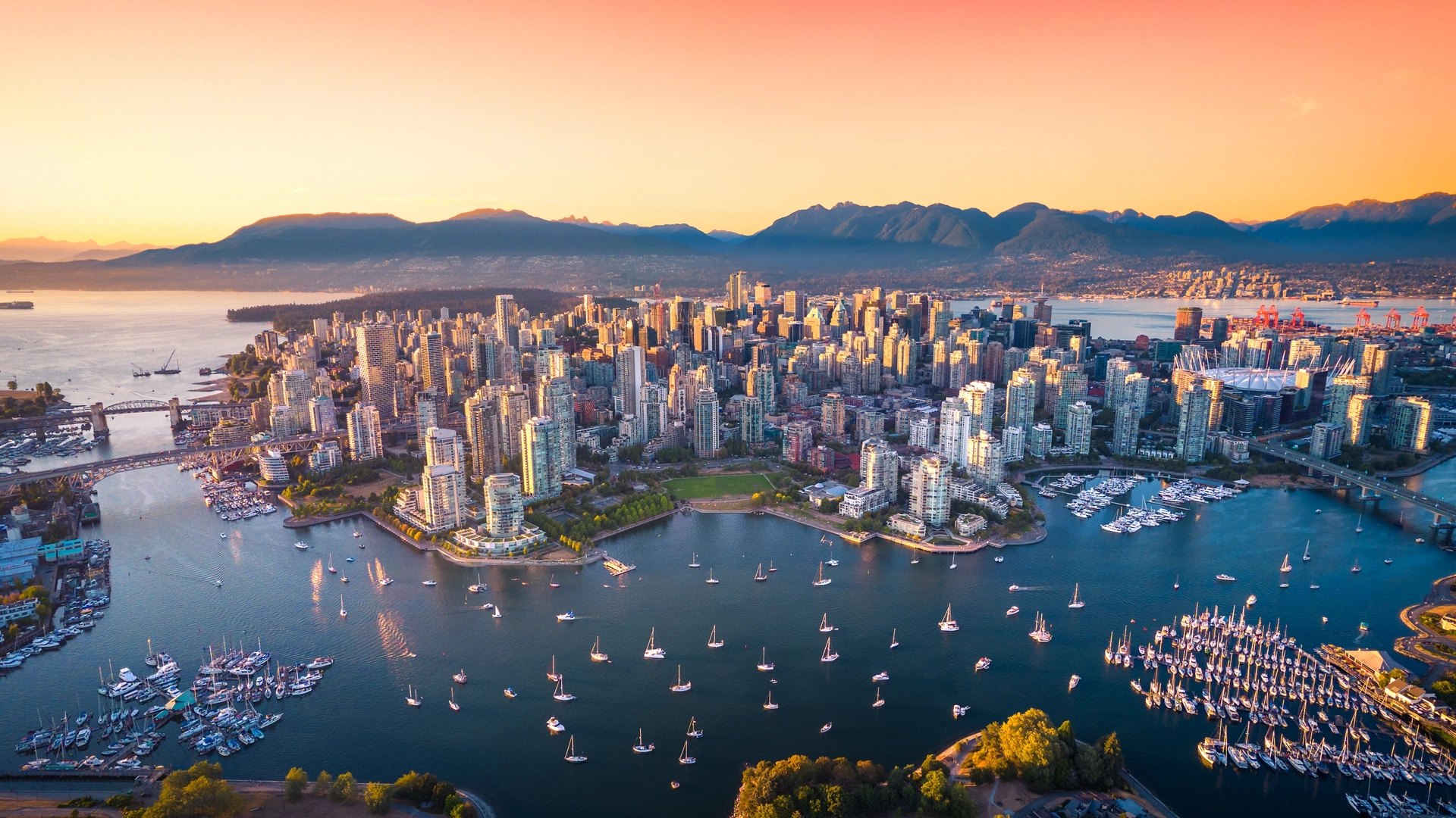 Aerial view of downtown Vancouver, False Creek and the North Shore mountains at golden hour