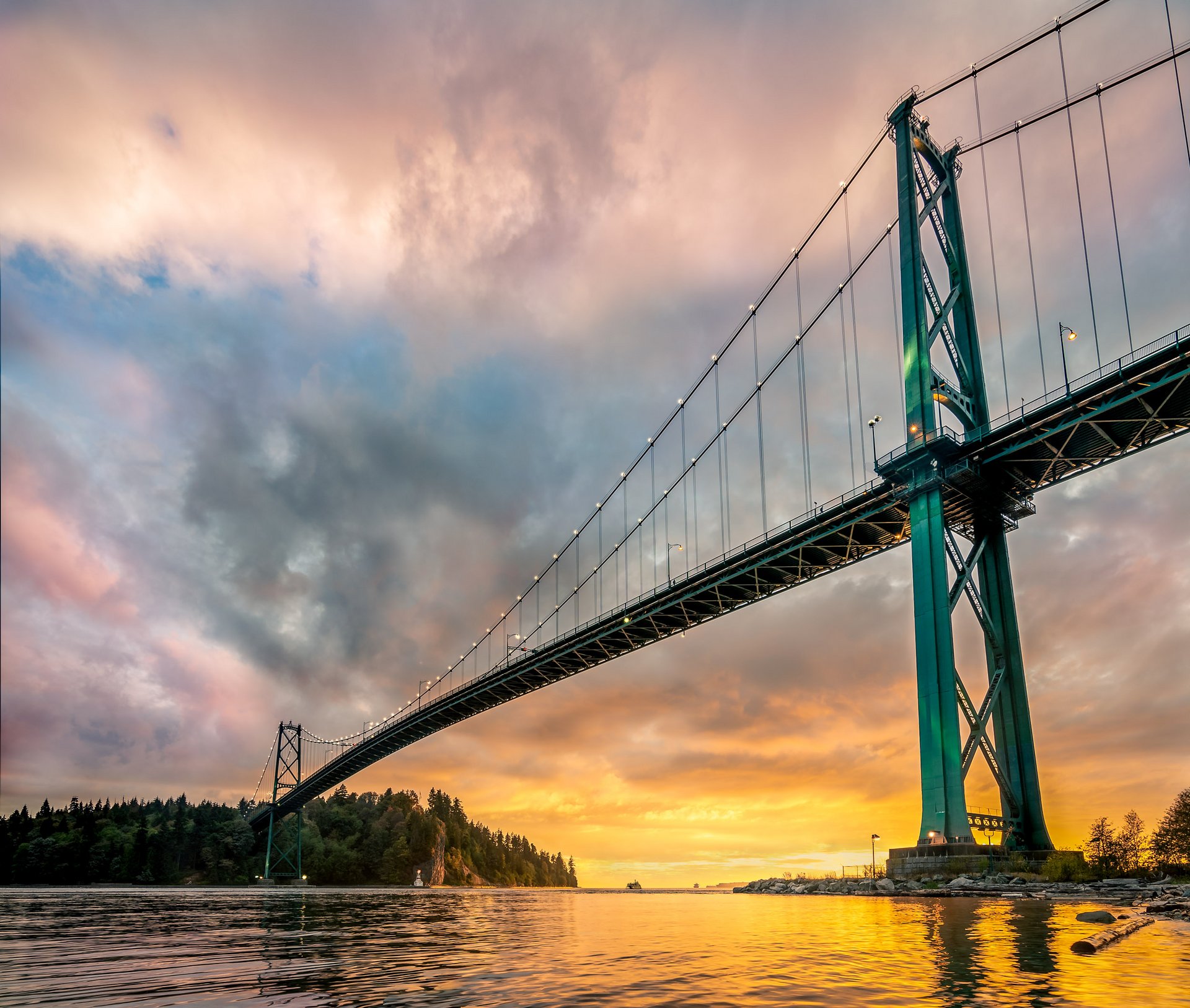 The Lions Gate Bridge over Burrard Inlet at sunset, seen from the West Vancouver shoreline